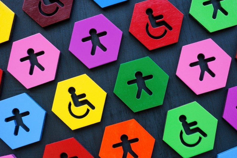 Inclusion and diversity. Colorful plates with figurines and disable person sign.