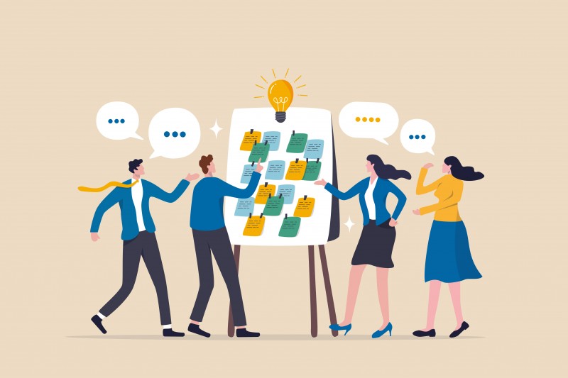 Workshop or business discussion, meeting or brainstorm new idea, training course class, Q and A, question and answer chat, business people in workshop meeting room with whiteboard and sticky notes.