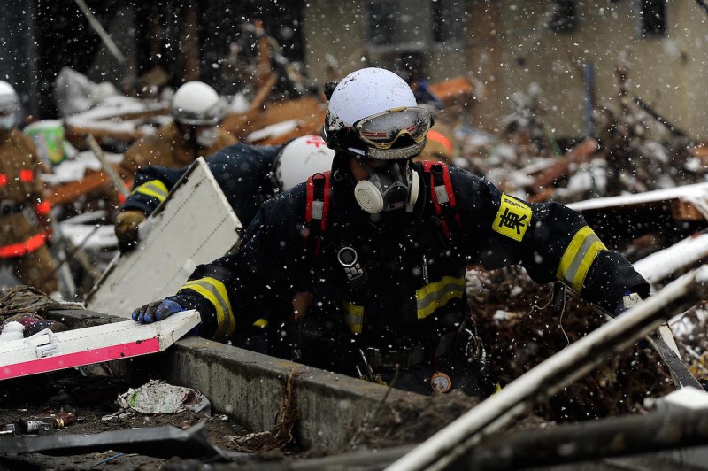 A member with the Japanese Search and Rescue team searches through the damage and debris on March 17, 2011, in Unosumai, Japan. A 9.0 earthquake hit Japan on March 11 that caused a tsunami that destroyed anything in its path.